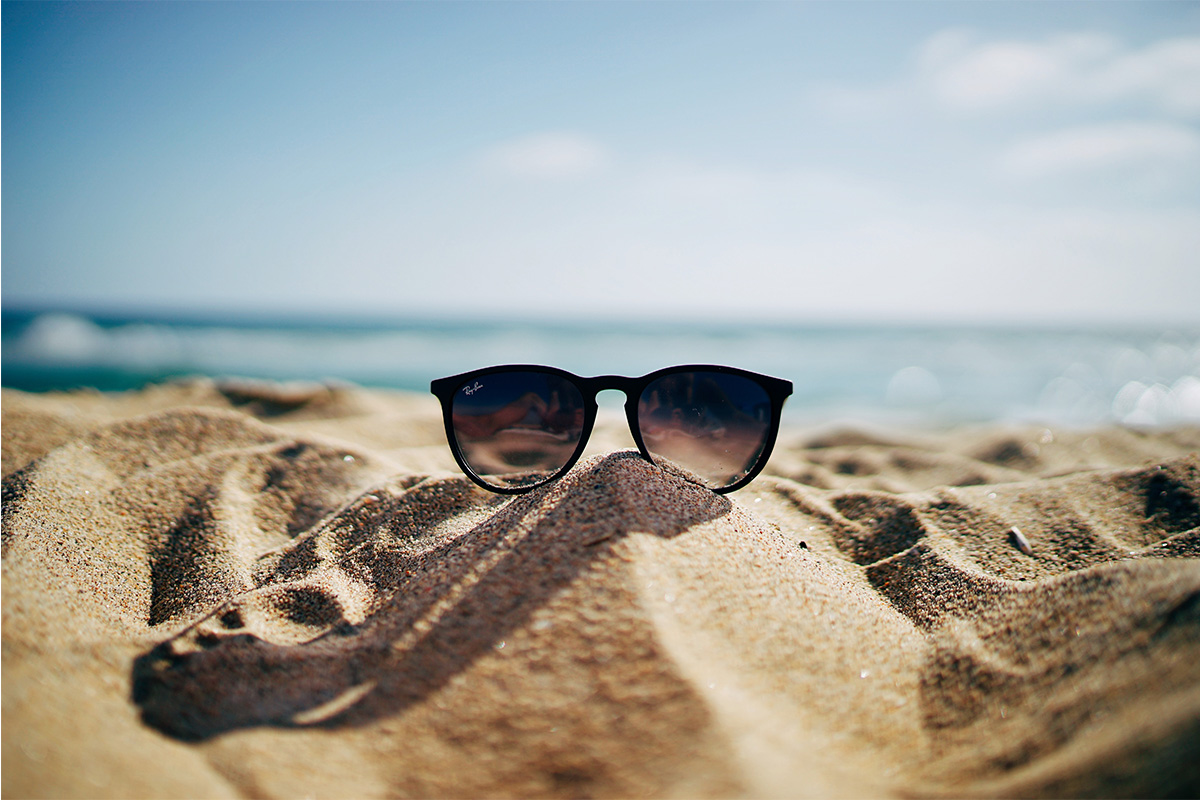 Photo of of sunglasses on the sand used on the home page of attorney Sara Yen's website (yenlaw.com).