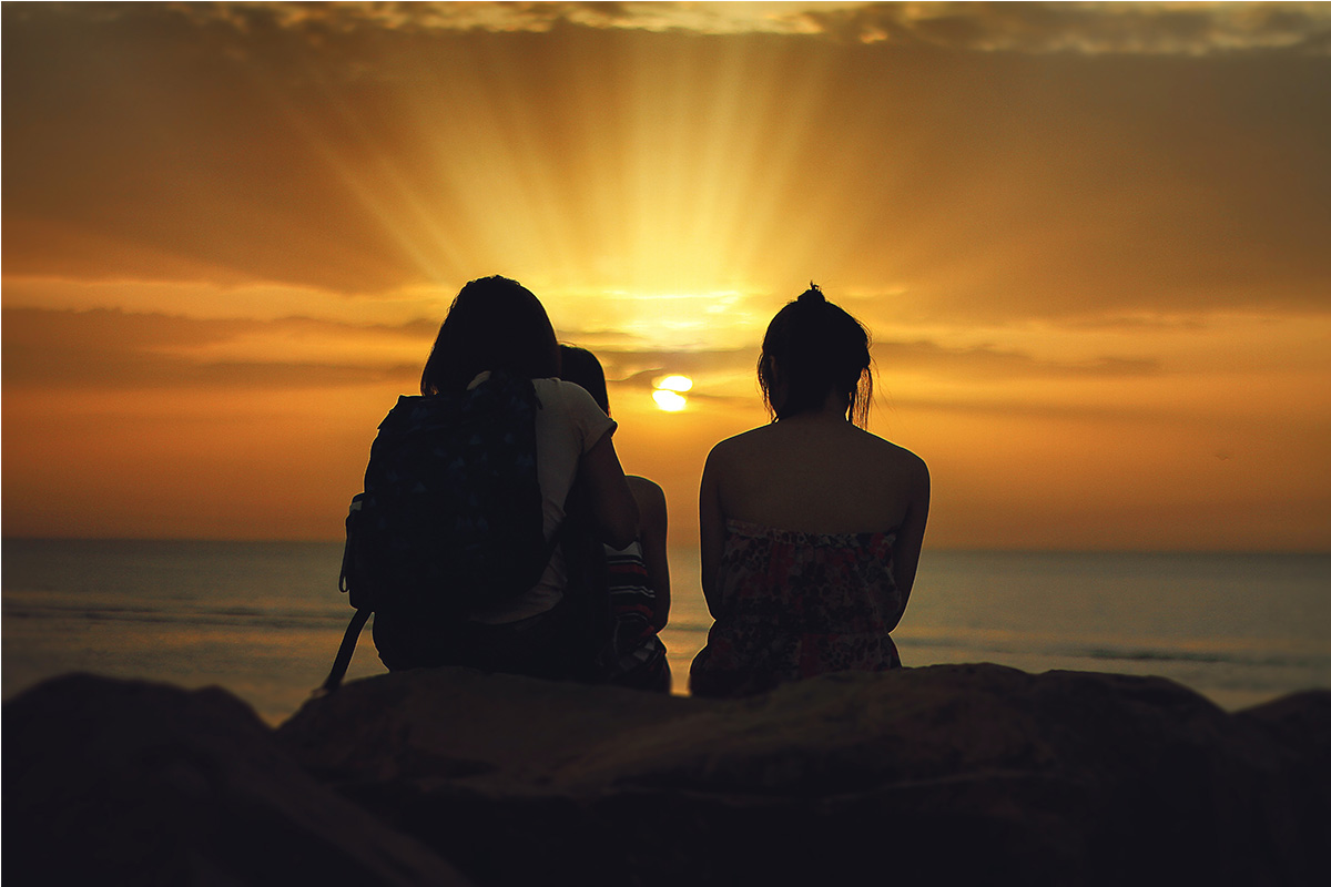 Photo of two people watching the sunset at the beach used on the home page of attorney Sara Yen's website (yenlaw.com).